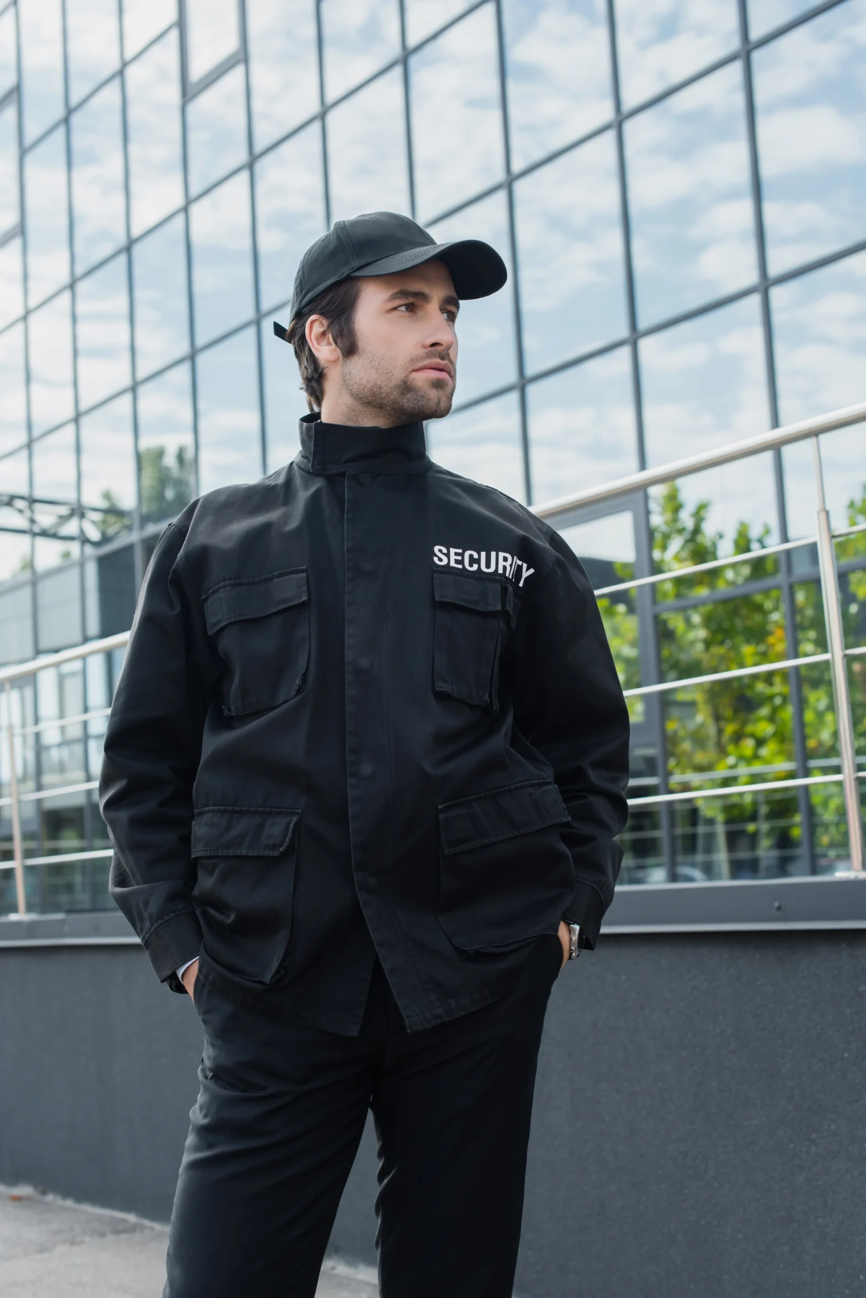 young-security-man-standing-with-hands-in-pockets